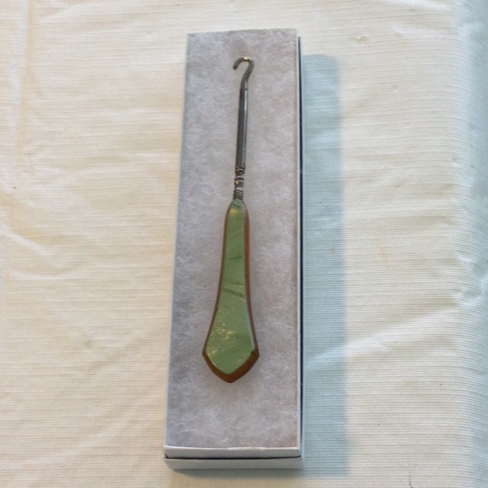 Vintage Button Hook Tool color green on one side brown on the other side.
